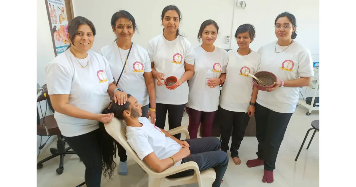 Students performing seated yoga asanas during certification course