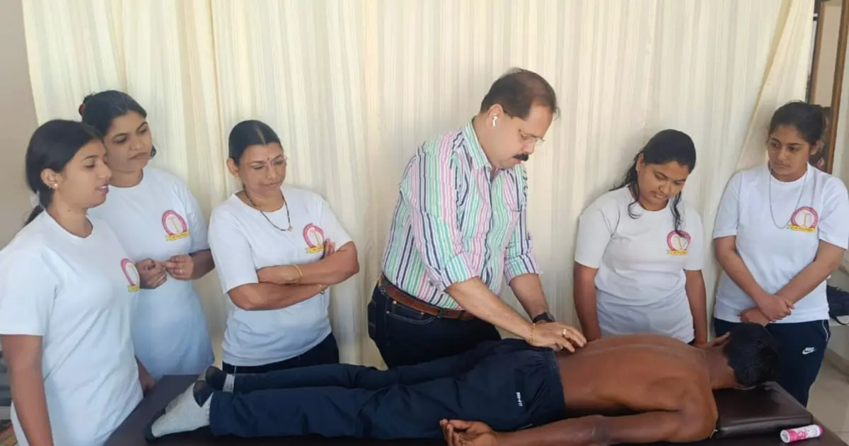 Students practicing partner yoga during practical training